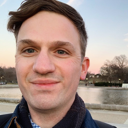 Matt Dobson (he/him) smiling happily at the camera